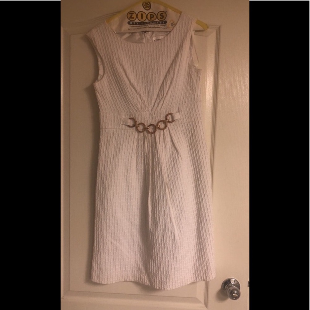 White mini dress with golden buckle design